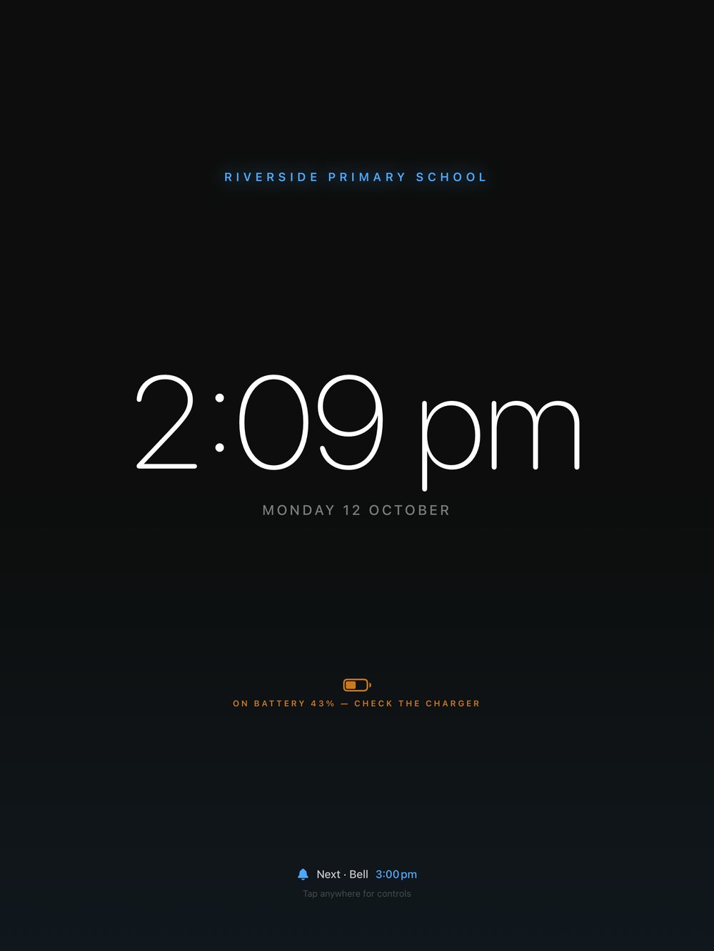 The clock display showing ON BATTERY 43% — CHECK THE CHARGER